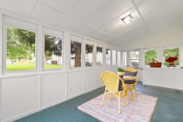 sunroom / solarium featuring vaulted ceiling