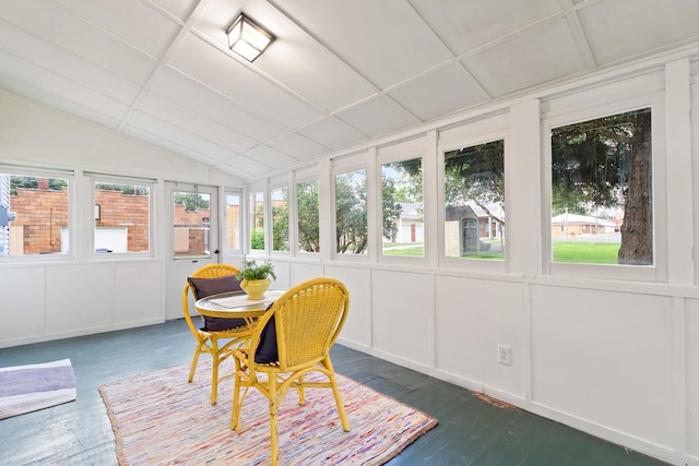 sunroom with lofted ceiling and a healthy amount of sunlight