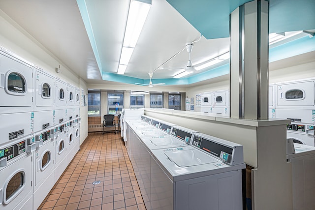 clothes washing area featuring dark tile patterned flooring, independent washer and dryer, ceiling fan, and stacked washer / drying machine