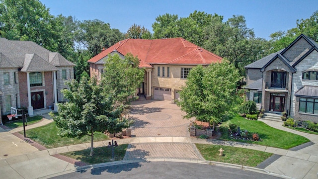 view of front of house featuring a front lawn and a garage