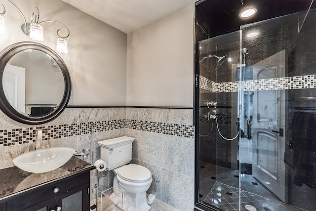 bathroom with toilet, walk in shower, tile walls, vanity, and decorative backsplash