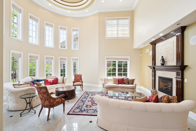 living room with light tile patterned floors, crown molding, and a towering ceiling