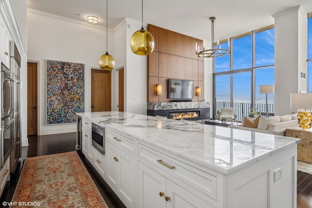 dining room featuring an inviting chandelier, dark hardwood / wood-style flooring, a wall of windows, and plenty of natural light