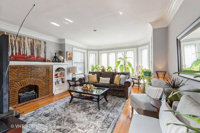 living room with ornamental molding, a fireplace, and hardwood / wood-style floors