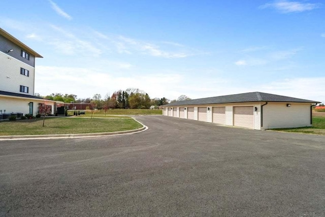 exterior space featuring curbs and community garages