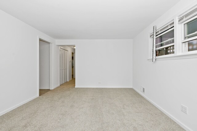 spare room featuring light colored carpet