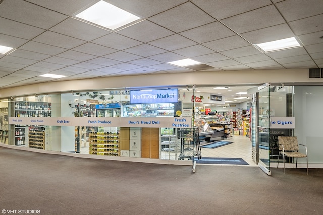 interior space featuring carpet floors and a paneled ceiling