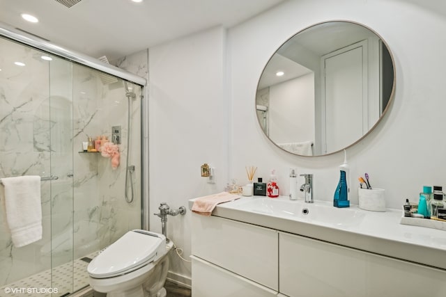 bathroom with vanity, walk in shower, and toilet