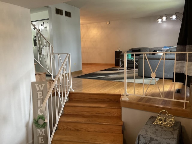 staircase with wood-type flooring