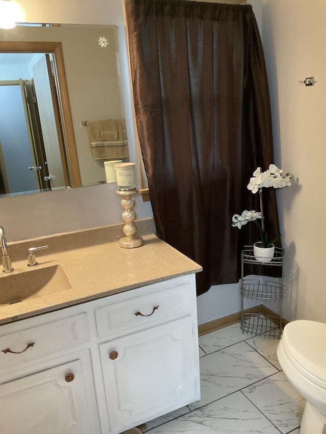 bathroom featuring vanity and toilet