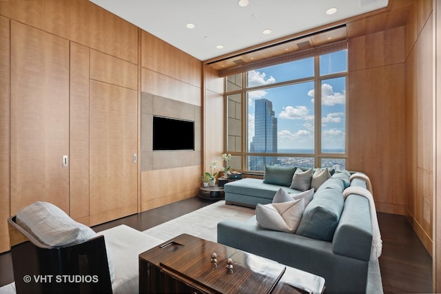 living area with expansive windows, recessed lighting, and wood finished floors