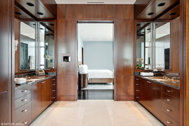 bathroom featuring a sink, ensuite bath, and two vanities