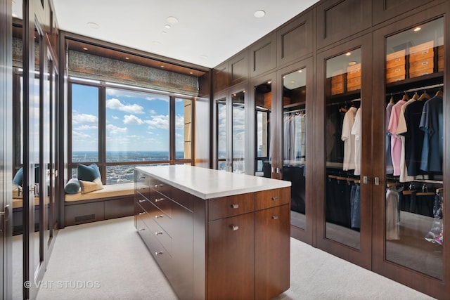 walk in closet with visible vents and light colored carpet