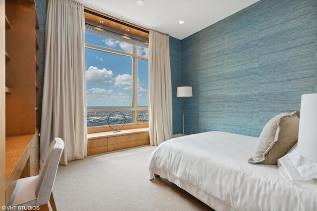 bedroom featuring light carpet, multiple windows, and recessed lighting