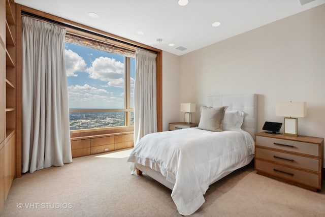 bedroom featuring light carpet and visible vents