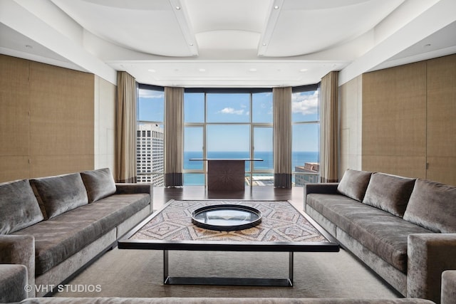 living room featuring expansive windows and a water view