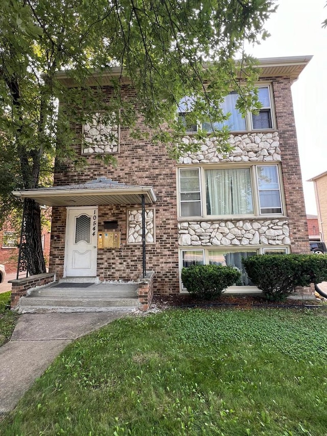 view of front of house with a front yard and a porch