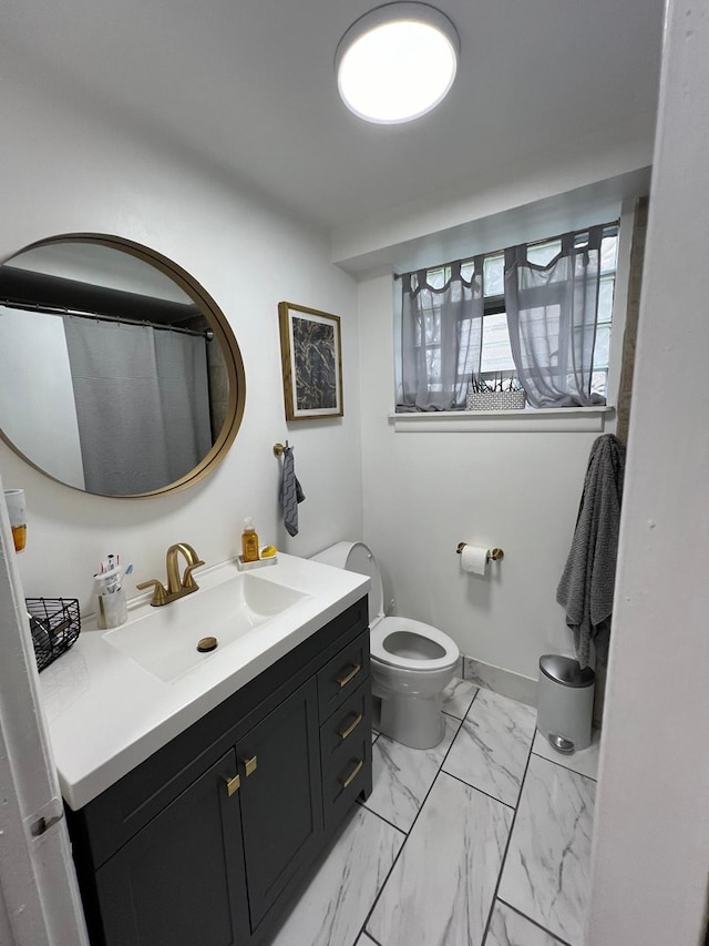 bathroom featuring toilet and vanity