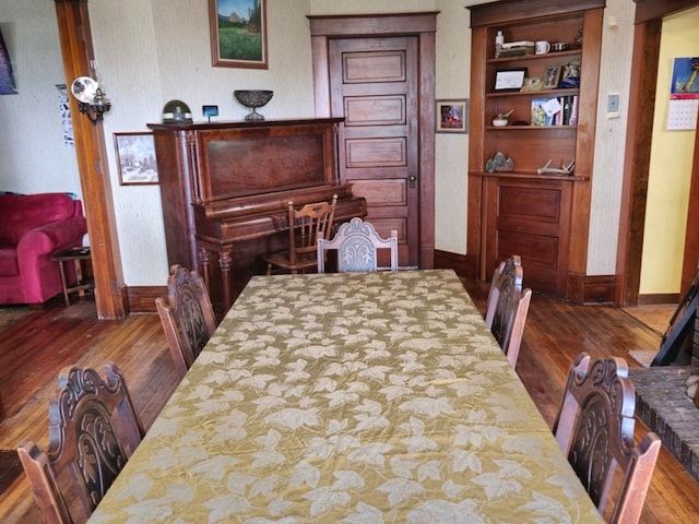 dining space with hardwood / wood-style flooring