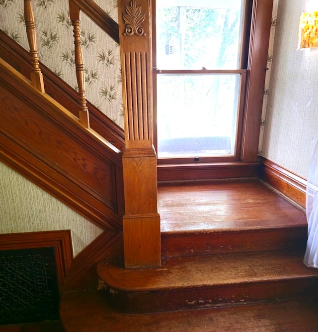 staircase with hardwood / wood-style floors