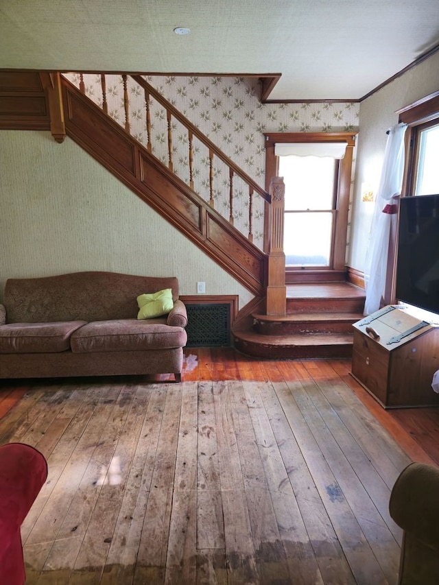 living room with plenty of natural light, hardwood / wood-style flooring, and ornamental molding