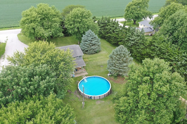 view of swimming pool with a rural view