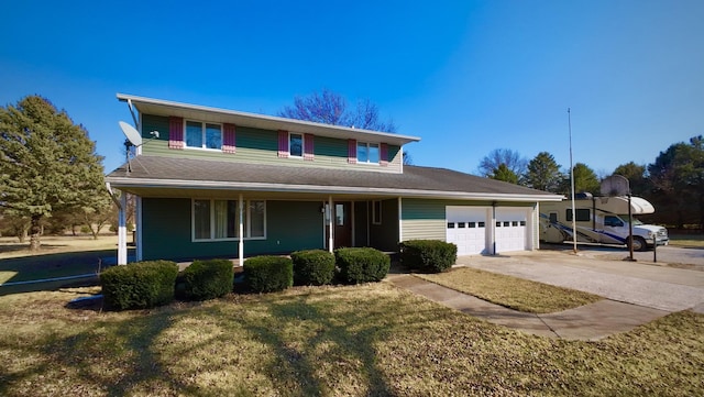 view of front of property with a front lawn, concrete driveway, and an attached garage