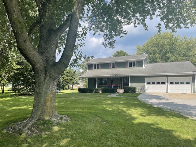 view of front of property with a garage and a front yard