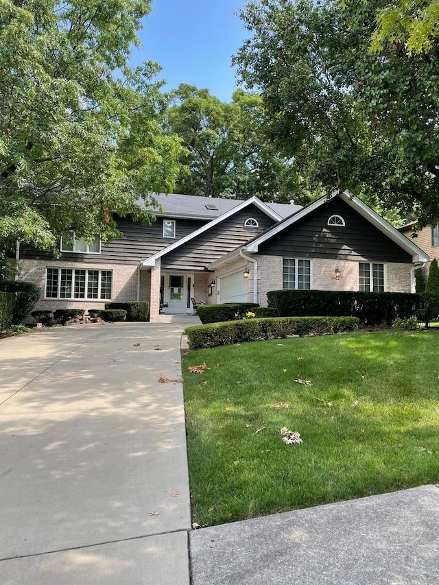 view of front of house featuring a garage and a front lawn