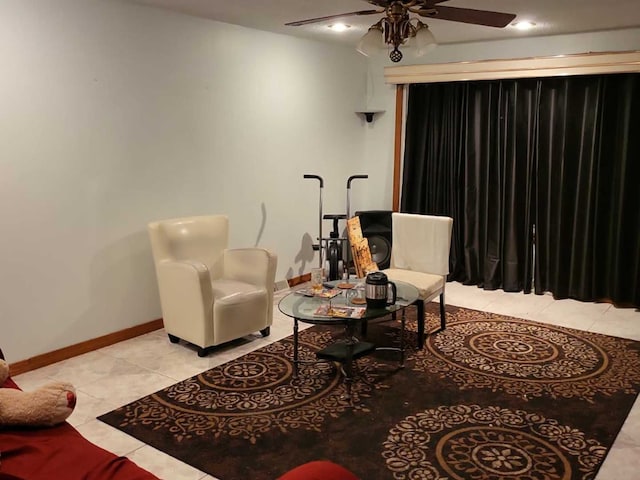 living area featuring ceiling fan and light tile patterned floors