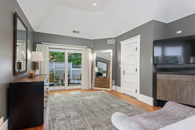 interior space with light hardwood / wood-style flooring and vaulted ceiling