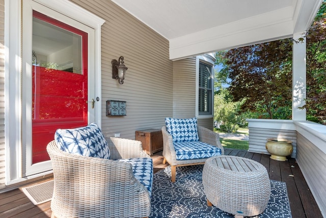 wooden deck featuring covered porch and visible vents