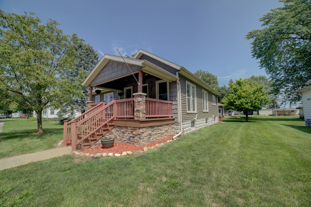 view of front of property with a deck and a front yard