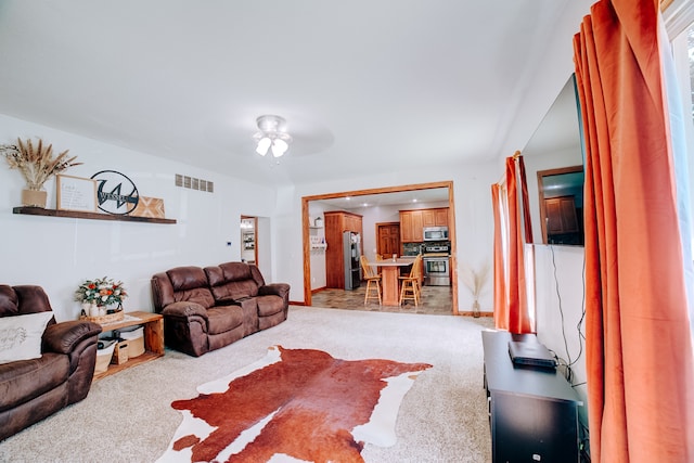 tiled living room featuring ceiling fan