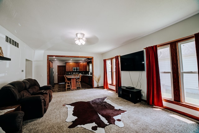 living room with carpet floors and ceiling fan