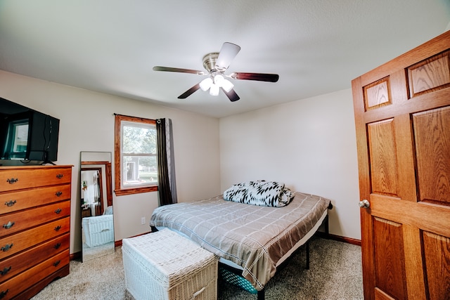 bedroom featuring light carpet and ceiling fan