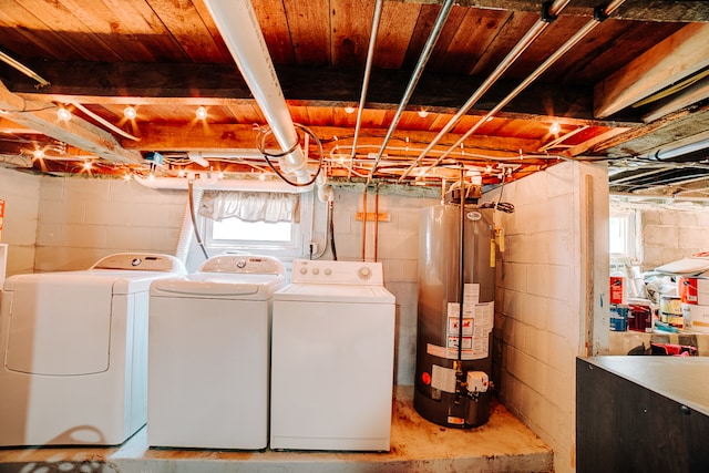 clothes washing area with washer and clothes dryer and gas water heater