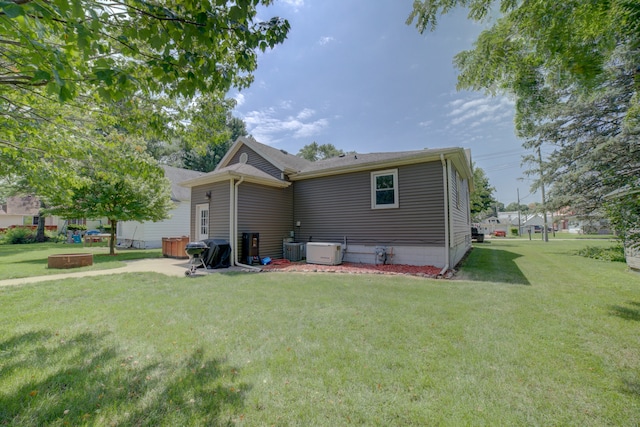 rear view of house featuring a yard