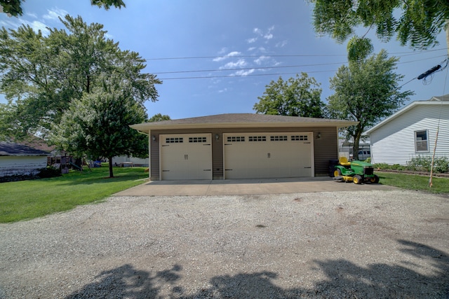 garage featuring a yard