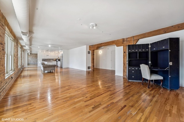 unfurnished living room with hardwood / wood-style flooring