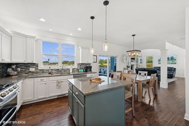 kitchen featuring dark wood-type flooring, white cabinetry, and a center island