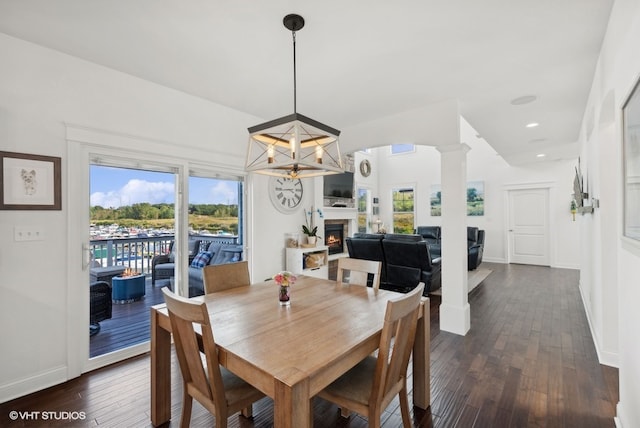 dining area with dark hardwood / wood-style floors and an inviting chandelier