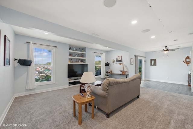 living room with ceiling fan, hardwood / wood-style flooring, and plenty of natural light