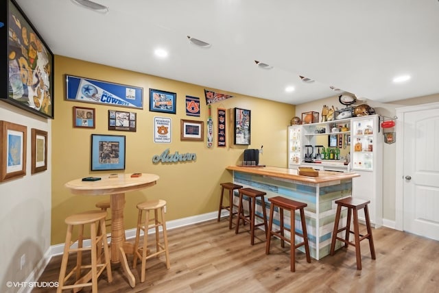 bar featuring light hardwood / wood-style flooring