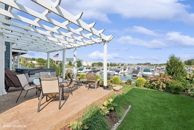 view of patio / terrace with a pergola and a water view