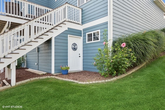 view of exterior entry with a lawn