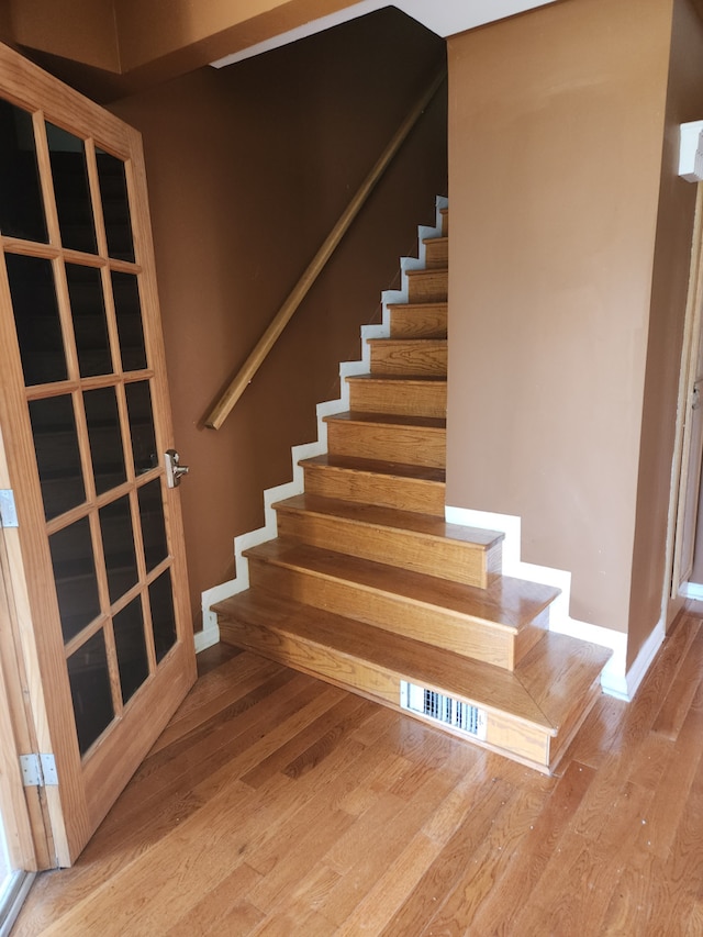 staircase with wood-type flooring