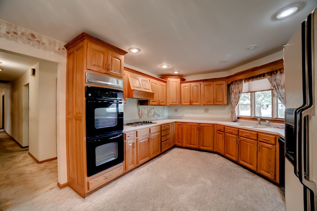 kitchen with premium range hood, black appliances, decorative backsplash, light carpet, and sink