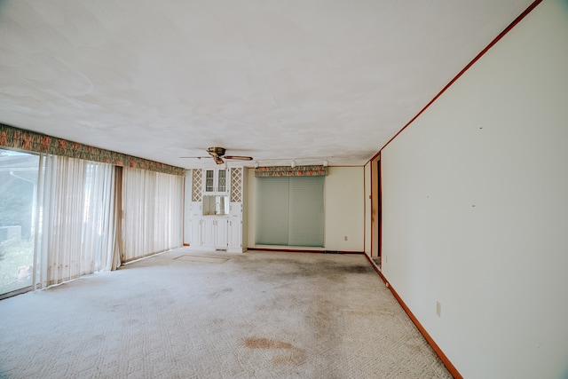 spare room featuring carpet flooring and ceiling fan