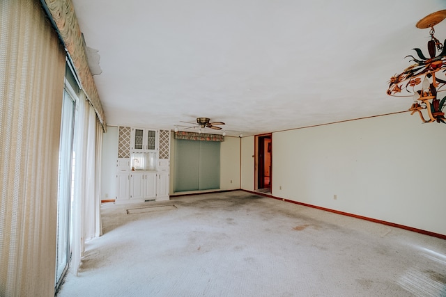 carpeted empty room with ceiling fan